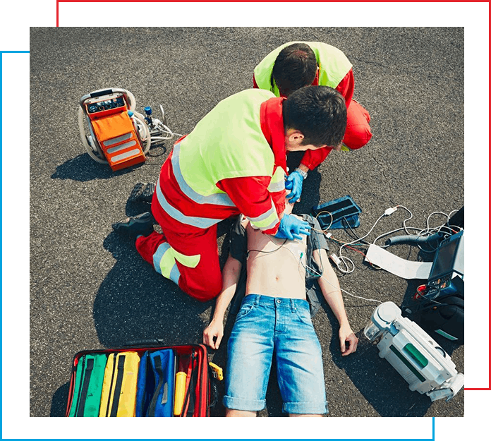 A person is being attended to by two emergency workers.